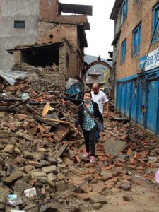 Menuka-Adaras-Health-and-Medical-Coordinator-climbs-over-rubble-to-deliver-health-services-350pxW