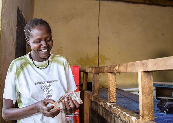 Catherine Nabulon, 34, of Abulon, Kenya, uses her E-wallet to procure safe drinking water for her family