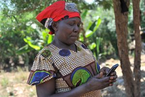 Digital technology helps farmers like Theresia Wairuba receive and repay loans via mobile phones.