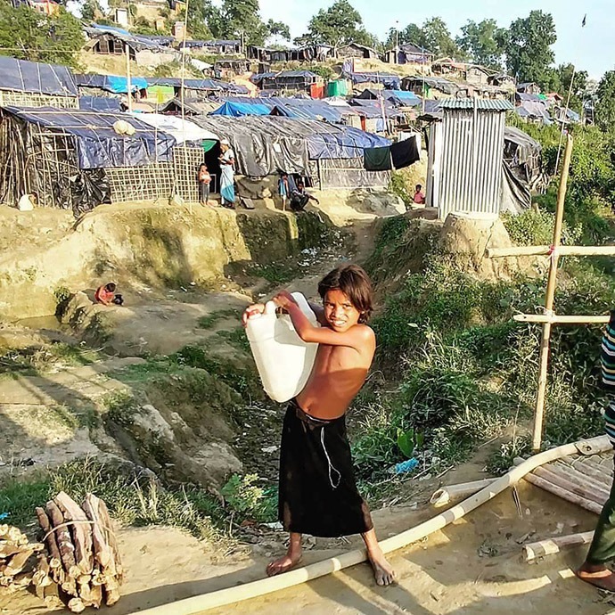 Youth with water jug Rohinga