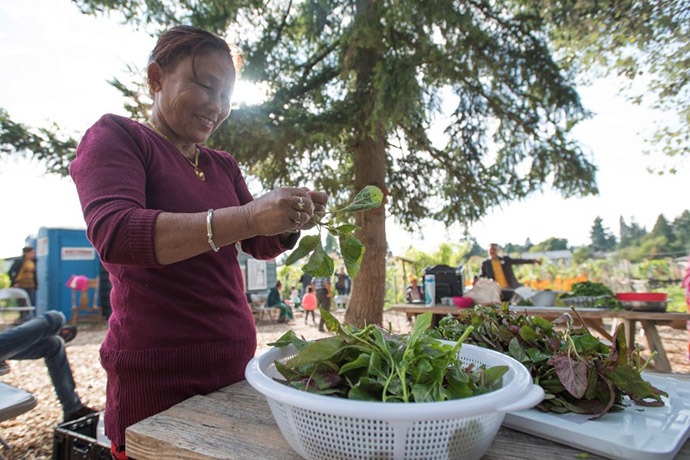 Woman participating in IRC's New Roots community garden program