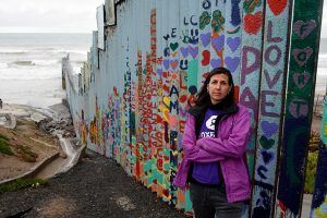 Oxfam America President Abby Maxman at the border wall separating the US and Mexico