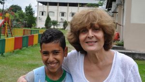 Mahnaz Javid poses with a student at The Association for Cohesive Development of the Amazon (ADCAM)