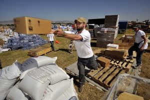 Americares relief workers unload a planeload of medicine and relief supplies