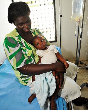 A young child receives intravenous fluids at an Americares-supported cholera treatment center