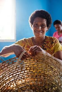 Fijian woman weaving a basket