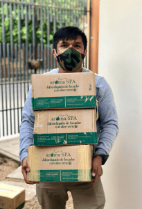 Pedro, a fisherman and youth leader in La Islila, Peru, carries boxes of donated soap to support the health of his fellow fishermen. Photo credit: Future of Fish.