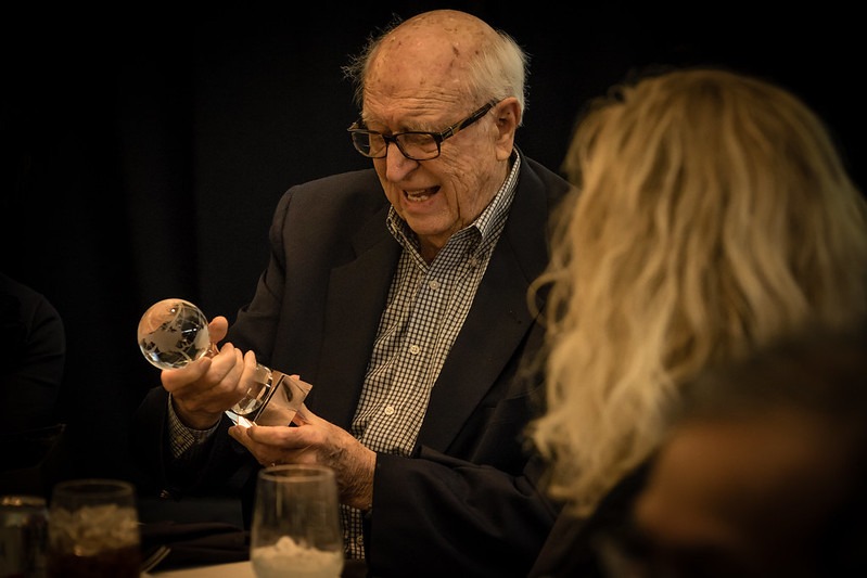 Bill Gates Sr. holding the Global Hero award, presented by Global Washington on December 10, 2015.