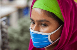 An apparel worker in Dhaka wears a face covering and maintains social distance from other workers as garment factories reopened amid the Covid-19 pandemic. Photo: UN Women/Fahad Abdullah Kaizer via Flickr.