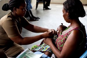 Nurse vaccinates baby