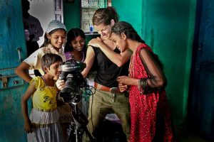 Young people inspecting camera