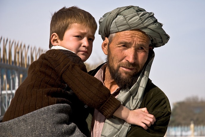 Man holding child in afghanistan