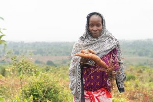 Zainabu, from Kisarawe district, Tanzania, holds cassava