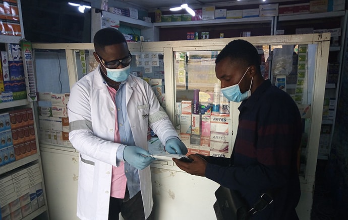 Dr. Ali Kitoko shares information on an HIV self-test at Pharmacie Binamet