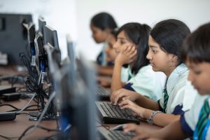 Students typing at computers