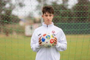 Athlete holding soccer ball