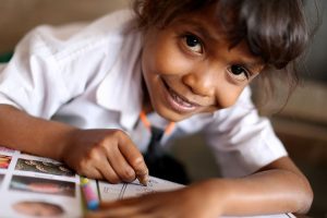 Smiling child drawing