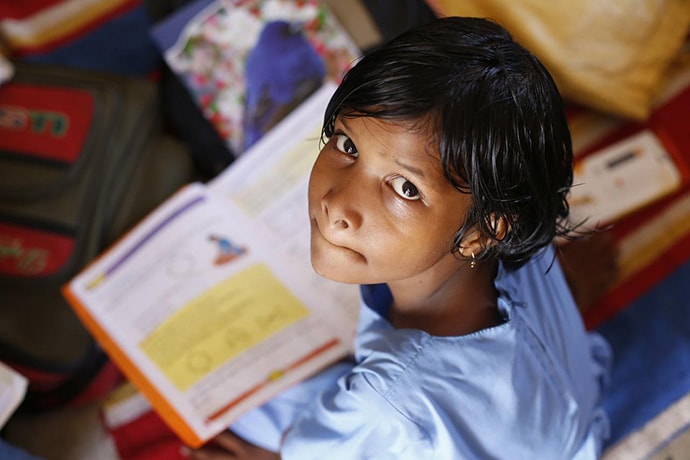 Young Indian schoolgirl reading