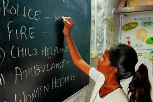 Student writing on chalkboard
