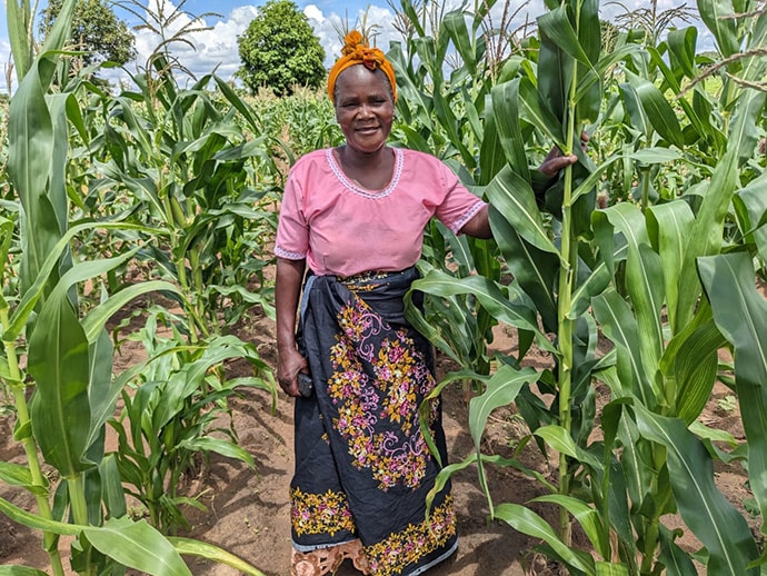 Joyce Phiri next to crops in field
