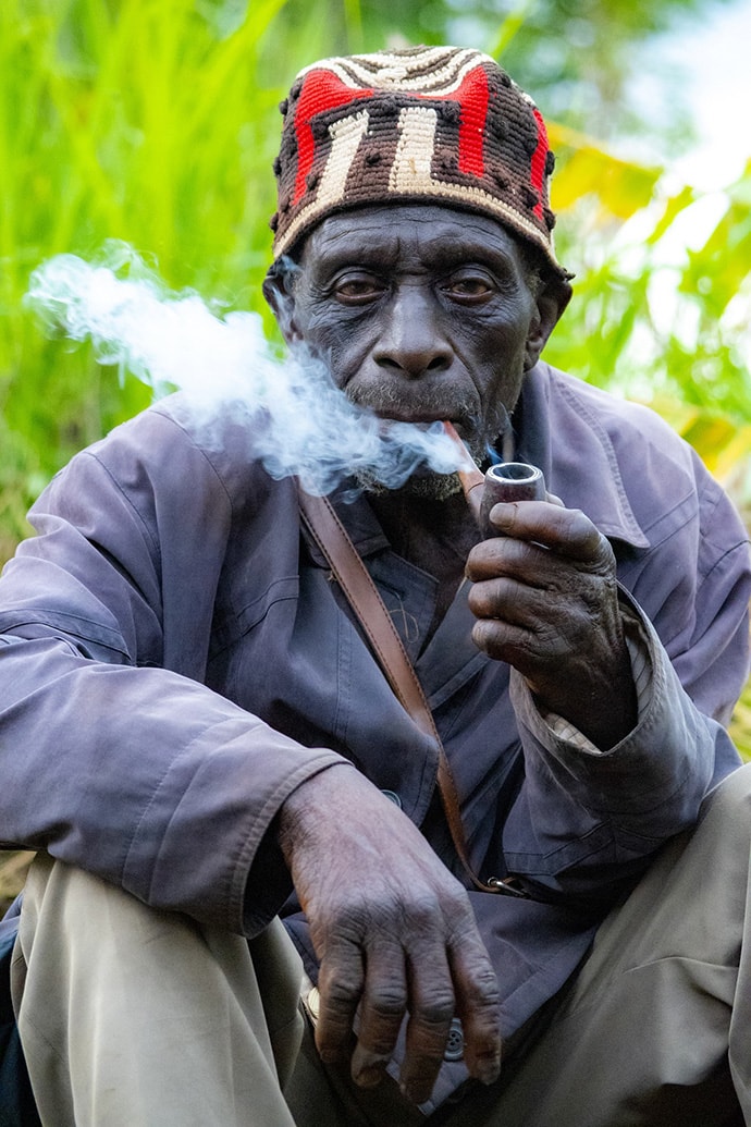 Elderly African man smoking