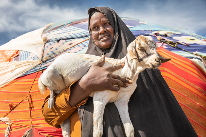 Woman holding goat in Somalia