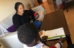 Oumo watches her child read