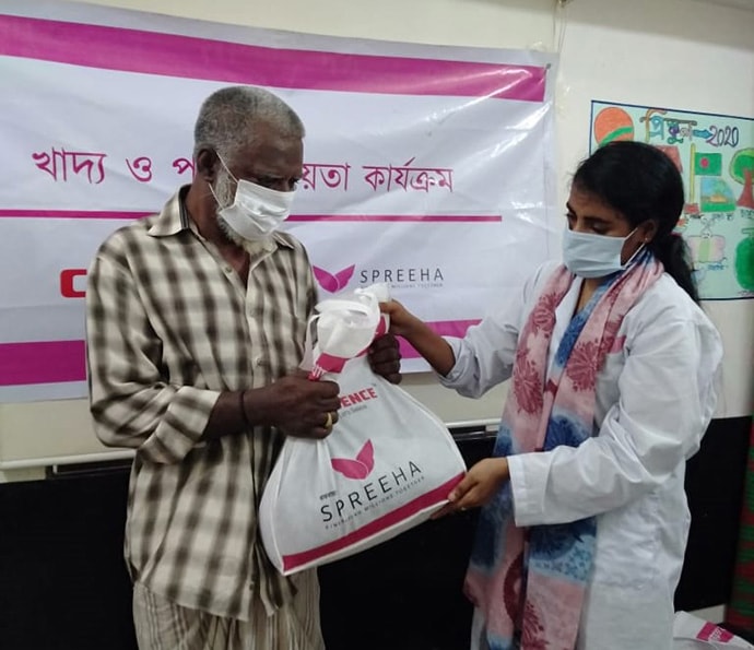 Health worker giving food package to man