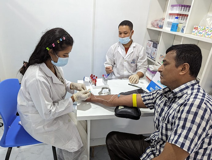 Health care worker collecting sample from patient