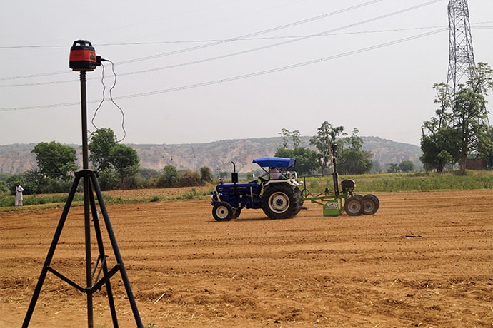 View of tractor in field laser land leveling