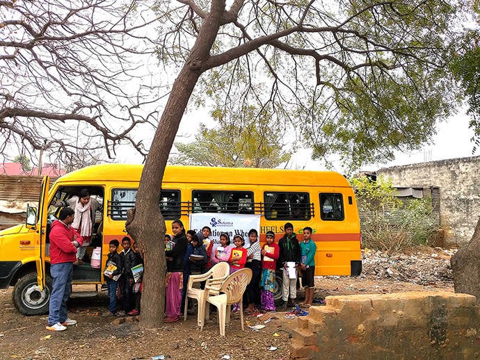 Photo of students in front of bus