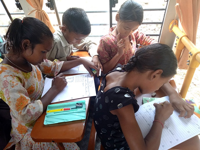 Photo of students working on bus