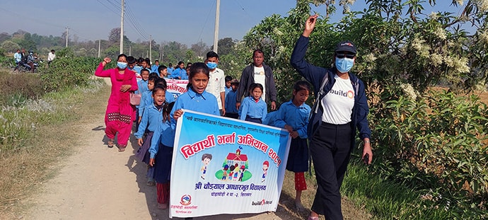 Photo of group carrying banner