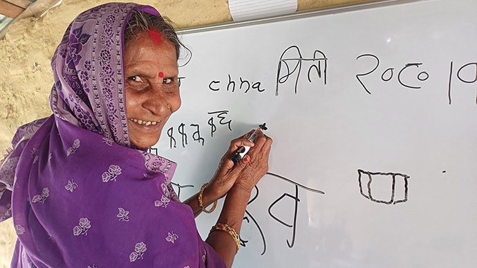 Photo of woman writing on white board