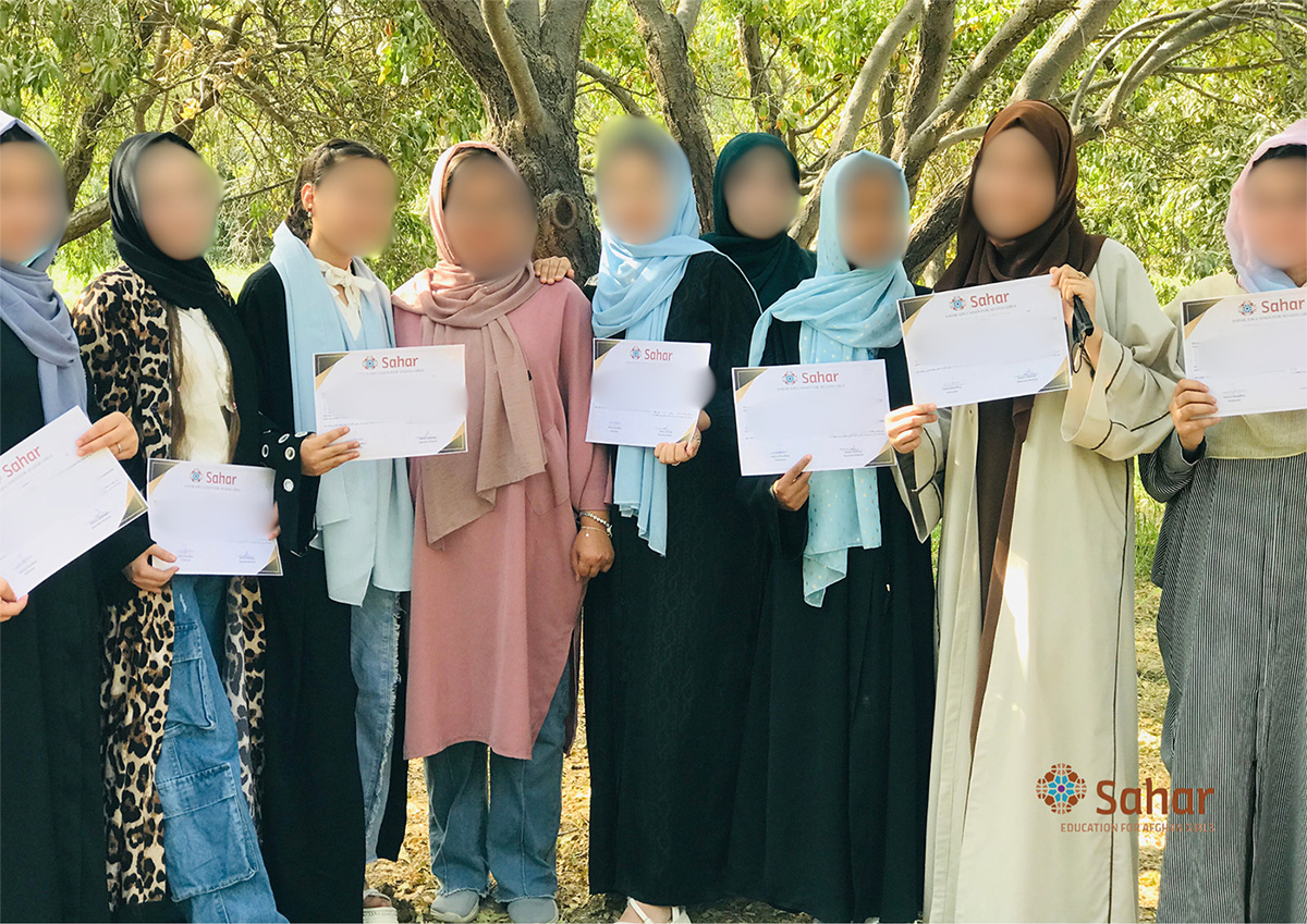 Photo of graduates holding diplomas