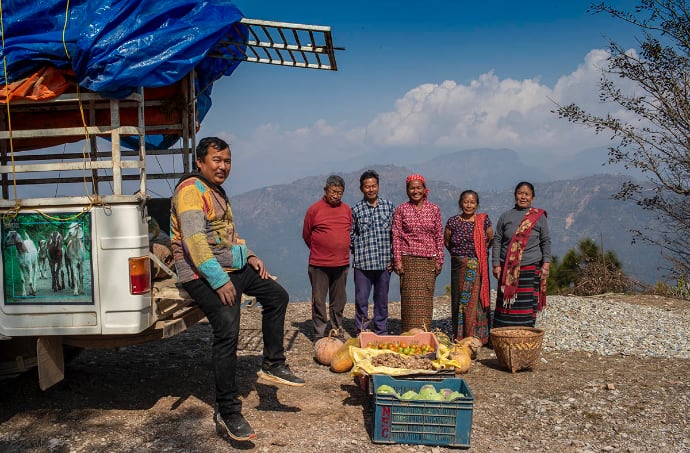 Photo of group outdoors with boxes of food