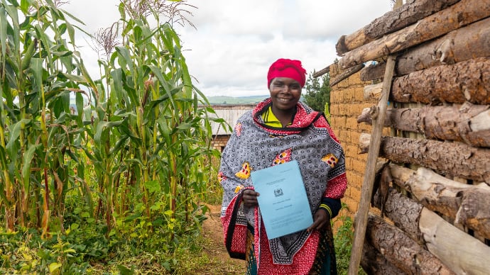 Photo of smiling woman holding certificate