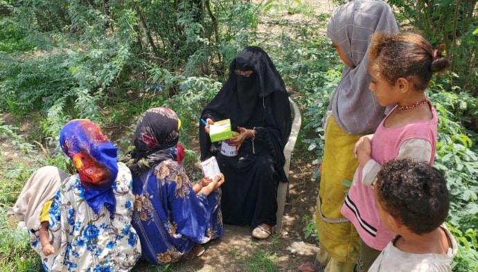 Photo of healthcare worker providing information to a group of mothers