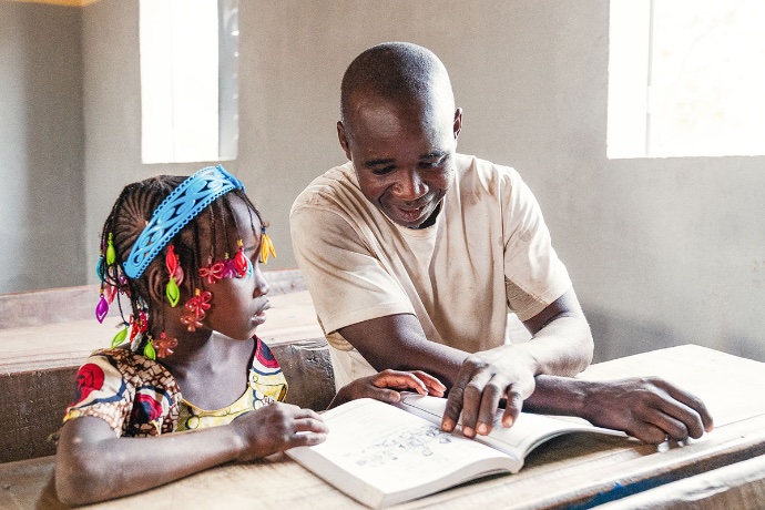 Father and daughter reading at desk