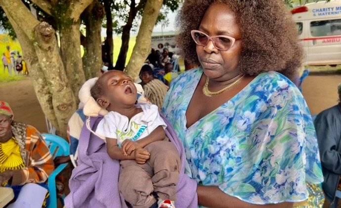 Alice Lamunu holding infant