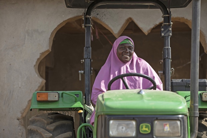 Photo of Hauwa Adamu Tamuzu driving a tractor