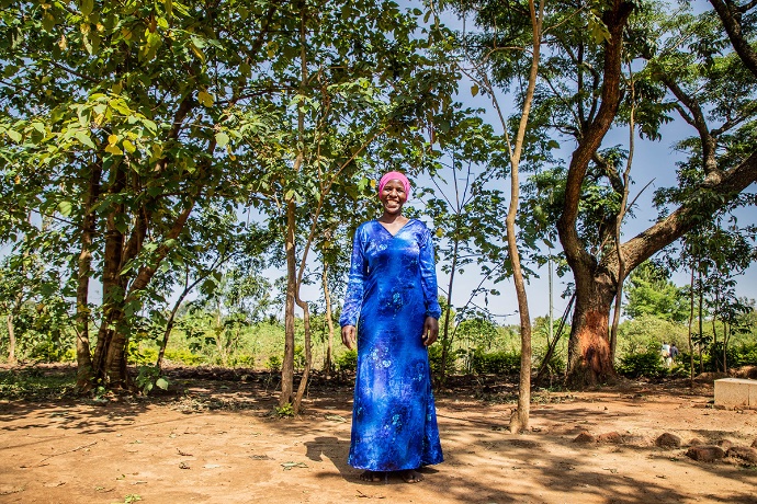 Photo of smiling woman posing outdoors