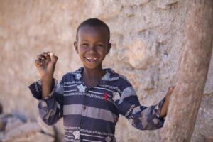 View of smiling child holding medicine
